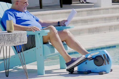 Man using Blu Tiger on outdoors by the pool and reading simultaneously 